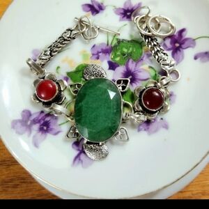 Beautifl,Oval Emerld Bracelet/2 Red Accent Stones. It's Very Ornate Around Stone